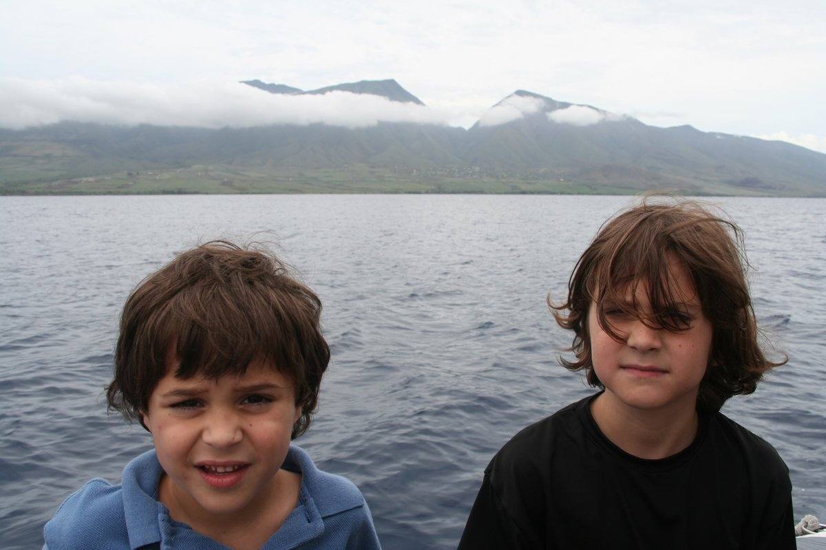 Cade and his brother Grey as children on a boat in Maui